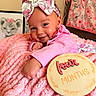 animal_drawing, baby, blanket, child, cute, decor, face, four_months, headband, infant, lying_down, milestone, nursery, pink_bow, pink_outfit, plush, portrait, smile, soft_texture, wooden_plaque