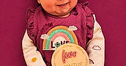 Alaina joined the competition — help win amazing prizes! baby, infant, smiling, headband, magenta, outfit, sign, five_months, cute, portrait, child, indoors, happy, sitting, colorful, clothing, hands, face, background, celebration