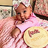 baby, infant, pink, blanket, bow, headband, milestone, four_months, cute, portrait, indoor, decor, soft_texture, animal_art, floral_pattern, clothing, child, face, smiling, toddler