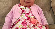 Alaina is registered to the contest to win money with this photo: baby, child, girl, bow, headband, pink_cardigan, floral_dress, pacifier, couch, smile, sitting, footwear, red_shoe, indoors, cute, portrait, young_child, happy, cozy, fabric