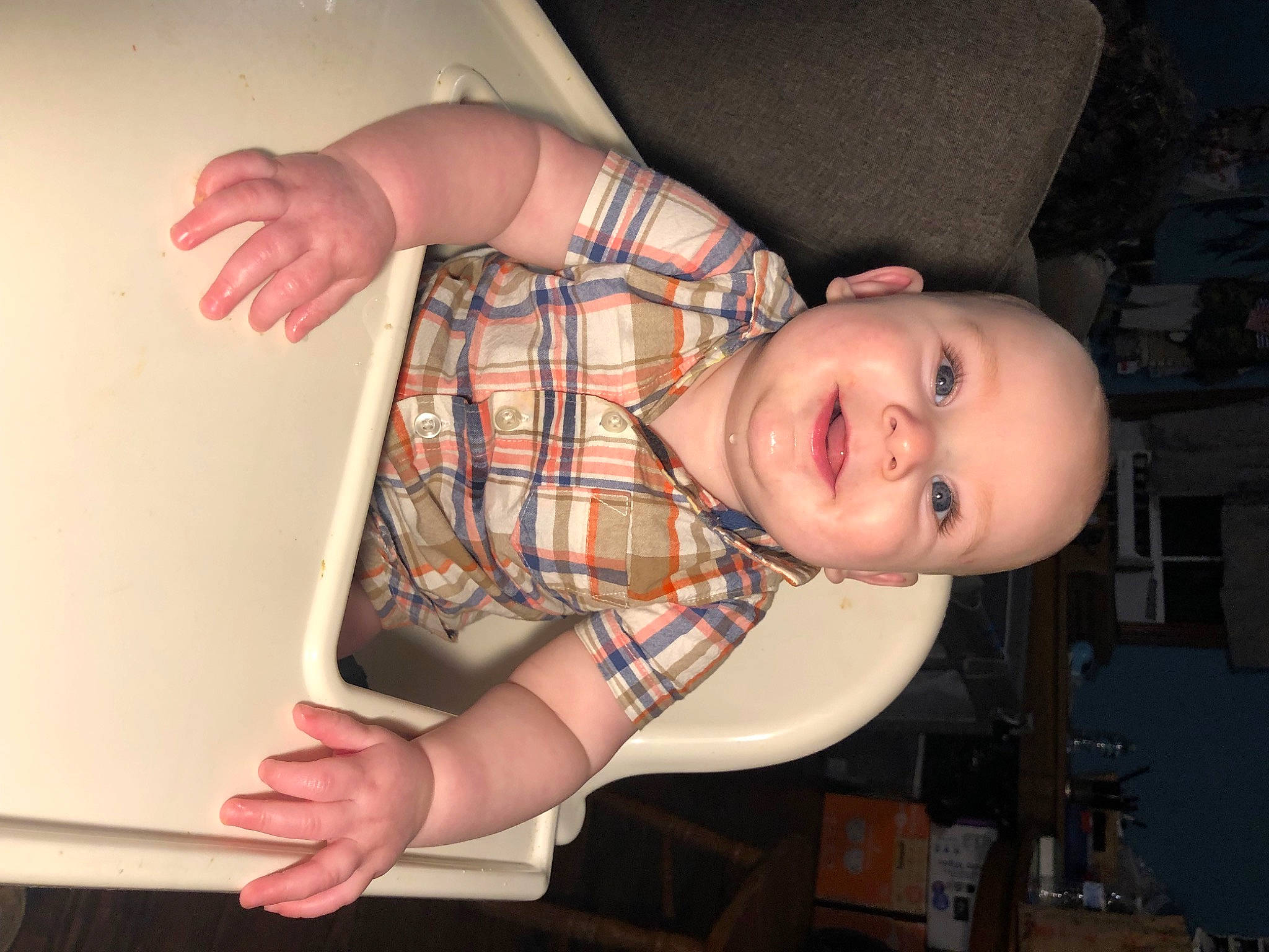 Langston is registered to the contest to win money with this photo: chest, child, elbow, flash_photography, fun, gesture, hat, human_body, human_leg, mouth, nose, pattern, person, plaid, sitting, smile, tartan, thigh, toddler, wood