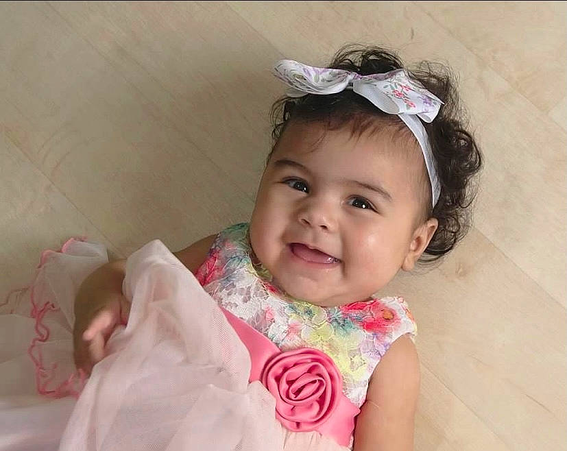 Gianna is registered to the contest to win money with this photo: baby, baby_toddler_clothing, bridal_accessory, cheek, chin, ear, eyebrow, eyelash, hair, hair_accessory, happy, head, headband, headpiece, iris, joy, person, pink, sleeve, smile