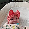 Willow is registered to the contest to win money with this photo: baby, infant, headband, pink, bow, blanket, pacifier, face, eyes, indoor, seat, mesh, cozy, cute, child, newborn, portrait, soft, comfort, clothing