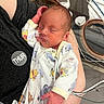 newborn, baby, infant, sleeping, hospital, medical_equipment, onesie, blanket, parent, arms, face, closed_eyes, cuddling, portrait, indoors, nursery, wires, monitor, cartoon_print, peaceful