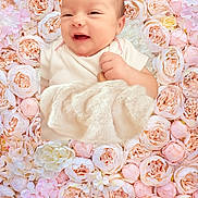 Alessia joined the competition — help win amazing prizes! baby, smiling, infant, blanket, flower, roses, floral_background, soft, cute, portrait, baby_clothing, closeup, head, face, skin, newborn, peaceful, lying_down, pastel_colors, decor