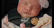 Addison is registered to the contest to win money with this photo: baby, blanket, car_seat, child, clothing, cozy, cute, face, headband, indoors, infant, newborn, pacifier, peaceful, pink_bow, portrait, seatbelt, sleeping, soft_texture, wrapped