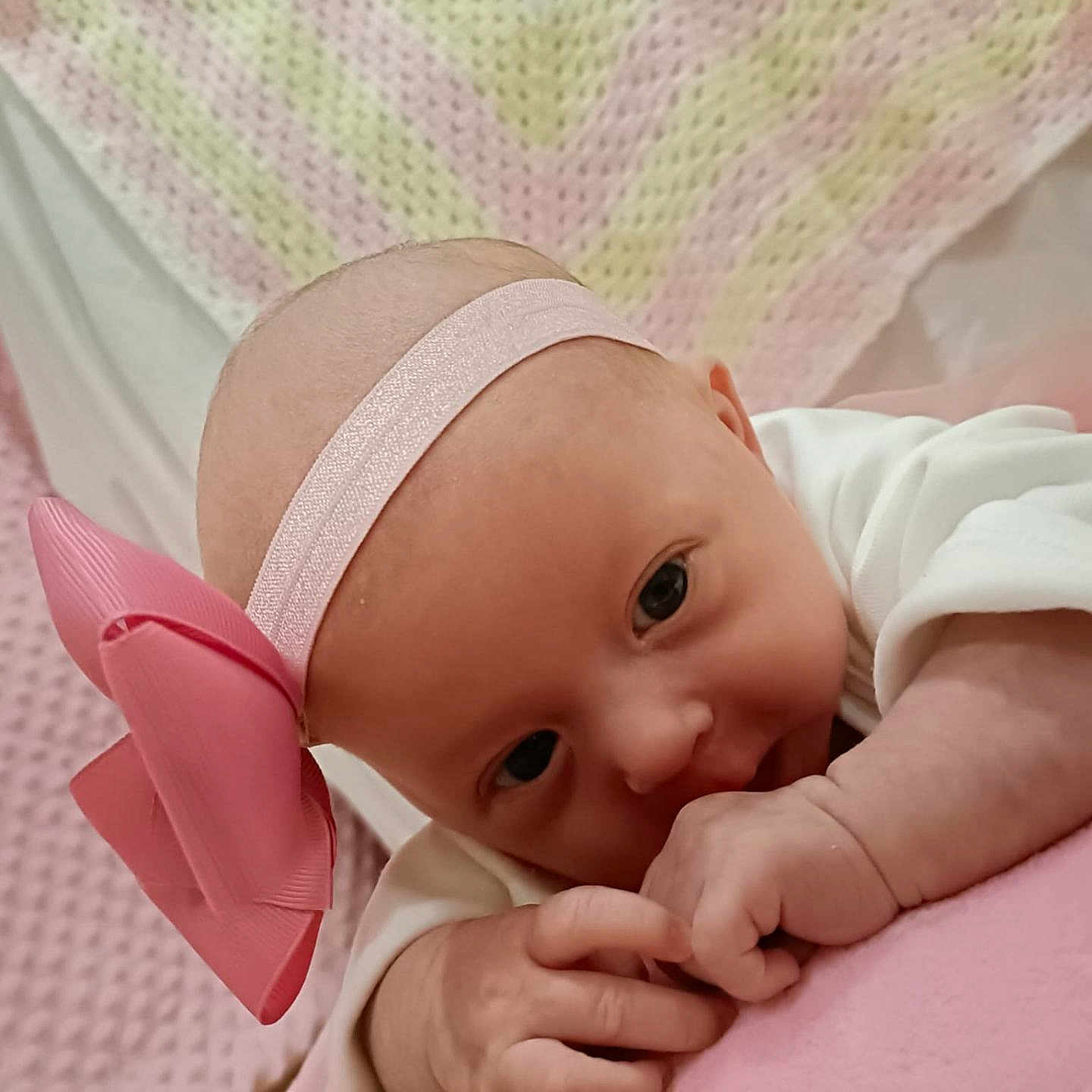 Bobbi-Leigh is registered to the contest to win money with this photo: accessories, baby, bed, bodypart, clothing, cushion, face, finger, furniture, hand, happy, hat, head, headband, newborn, person, photography, portrait, quilt, smile