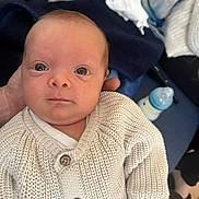 Khalifa participe au concours pour gagner de l'argent avec cette photo : baby, blanket, blue, bottle, closeup, clothing, cozy, cute, expression, face, hand, human, indoor, infant, knitwear, newborn, person, portrait, soft, sweater