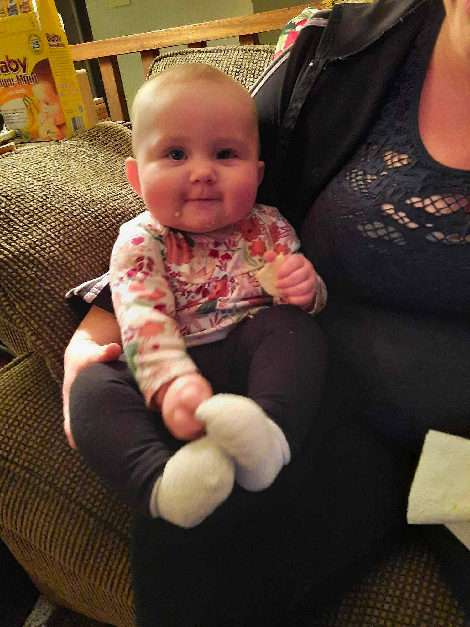 Hadleigh is registered to the contest to win money with this photo: arm, baby, baby_toddler_clothing, cheek, child, comfort, finger, hand, happy, head, human_body, lap, leg, person, skin, sleeve, smile, sock, thigh, thumb