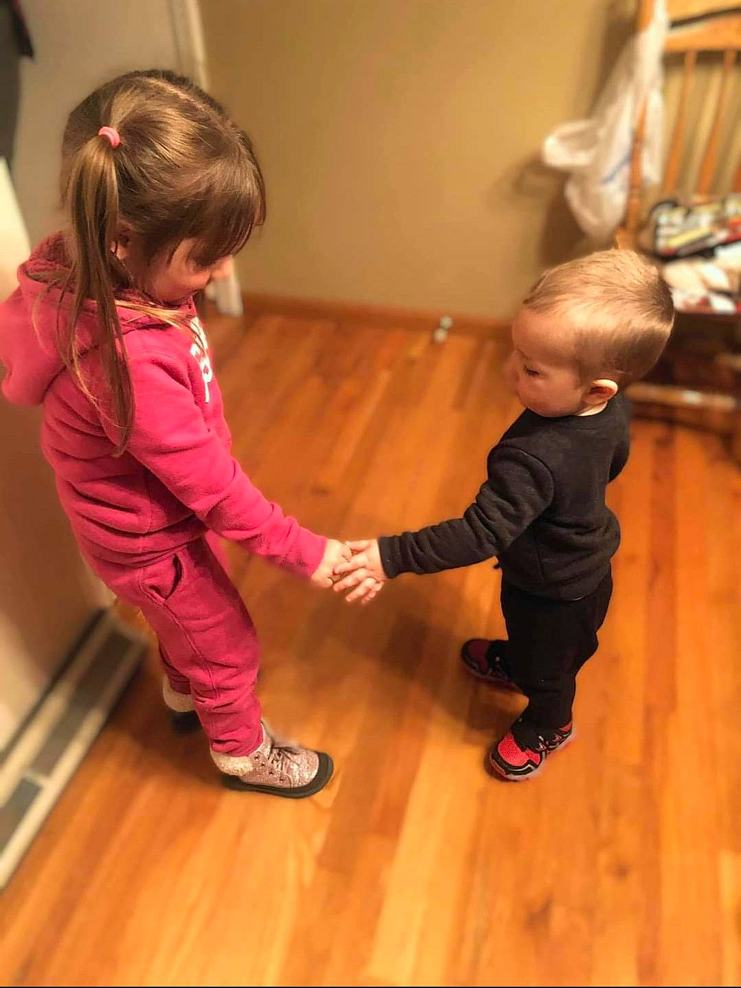 Hailie joined the competition — help win amazing prizes! baby_toddler_clothing, child, door, floor, flooring, fun, gesture, hardwood, joint, laminate_flooring, leg, mammal, outerwear, person, sneakers, standing, toddler, varnish, wood, wood_flooring