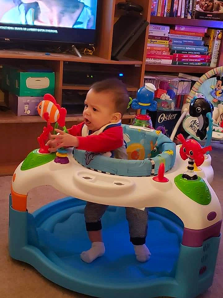 Xavier is registered to the contest to win money with this photo: baby, baby_products, cable_television, child, display_device, event, fun, games, leisure, person, plastic, play, recreation, riding_toy, room, shelf, television, television_set, toddler, toy