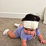 Zoe is registered to the contest to win money with this photo: baby, infant, child, crawling, headband, onesie, sock, carpet, indoor, wall, bow, chubby_cheeks, dark_hair, cushion, arm, wrist_bracelet, looking_down, portrait, cute, floor