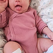 Louna a rejoint le concours — aidez-le/la à gagner de superbes lots ! baby, infant, tongue_out, pink_onesie, white_socks, polka_dots, blanket, koala_pattern, stars, cute, playful, lying_down, soft_texture, child, smiling, cozy, indoor, portrait, skin, hand