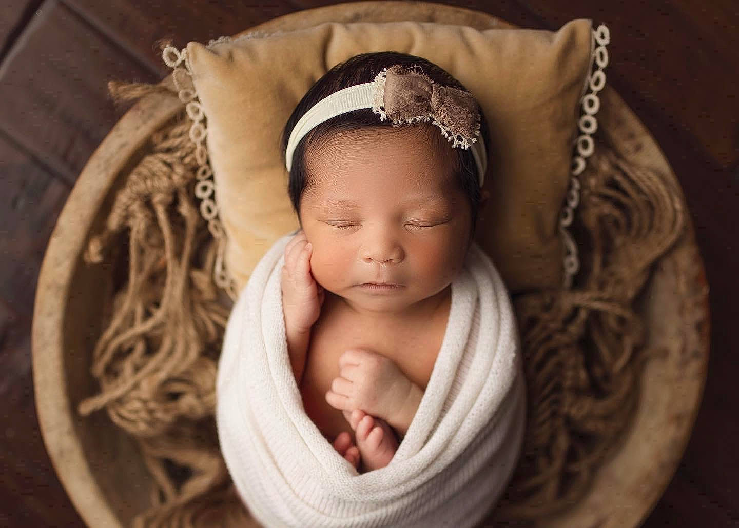 Aleia is registered to the contest to win money with this photo: arm, baby, baby_products, baby_toddler_clothing, cap, comfort, eye, eyelash, face, flash_photography, happy, head, headband, headpiece, iris, jewellery, linens, person, toddler, wood
