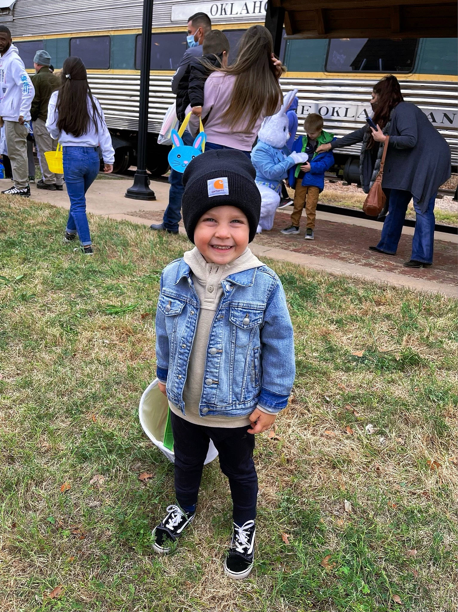 Callum joined the competition — help win amazing prizes! blurred, child, city, clothing, event, footwear, fun, grass, happy, hat, headwear, jacket, jeans, joy, leisure, outerwear, person, recreation, shoe, smile