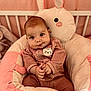 Alice participe au concours pour gagner de l'argent avec cette photo : baby, infant, plush, pink, cushion, soft_toy, cute, child, face, expression, cozy, clothing, furniture, indoor, portrait, smile, hands, seated, nursery, comfort