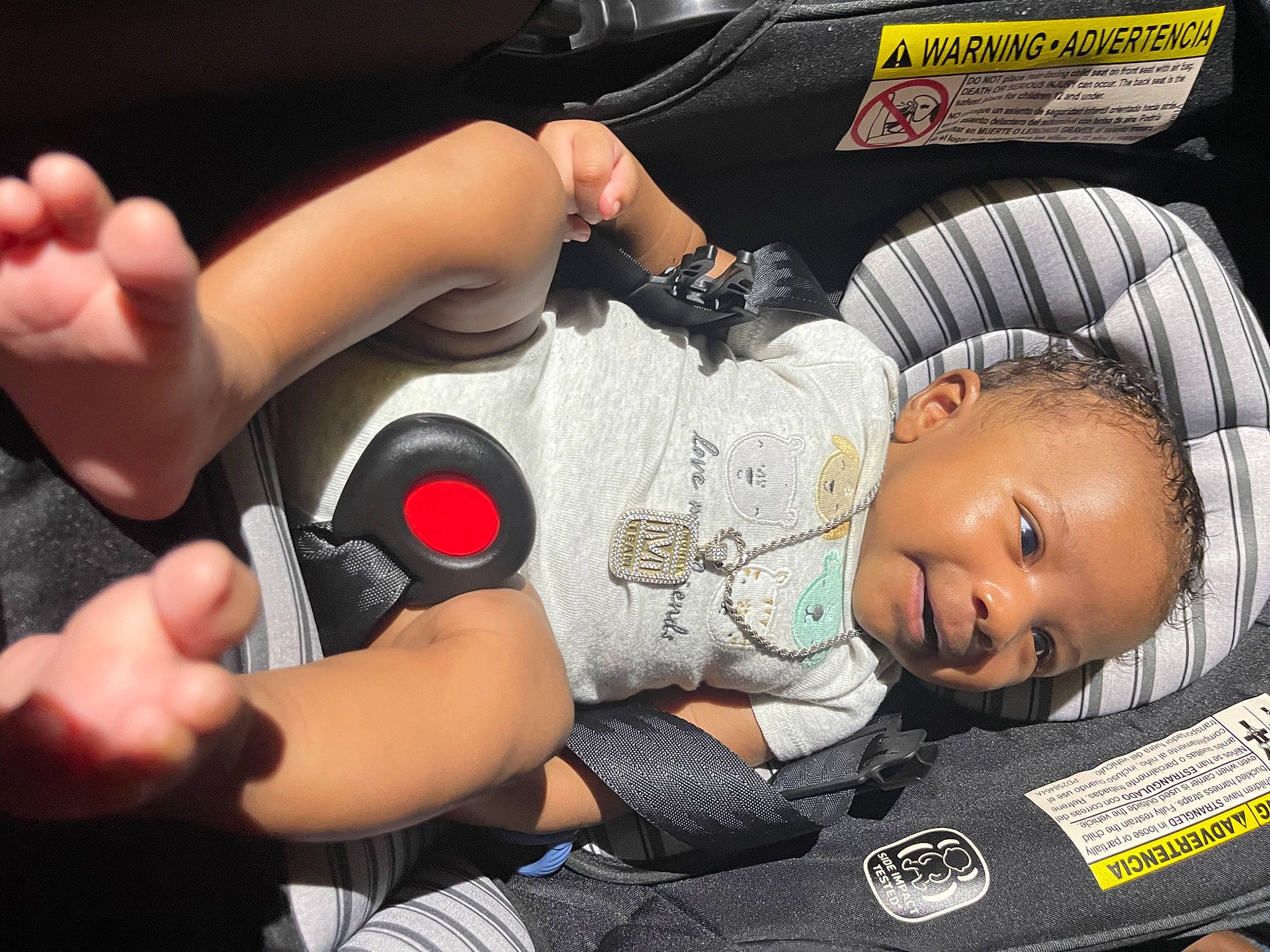 Nehemiah is registered to the contest to win money with this photo: audio_equipment, baby, baby_carriage, baby_products, car_seat, carmine, chest, child, comfort, elbow, fun, gesture, hand, human_leg, nail, person, sitting, thigh, thumb, toddler