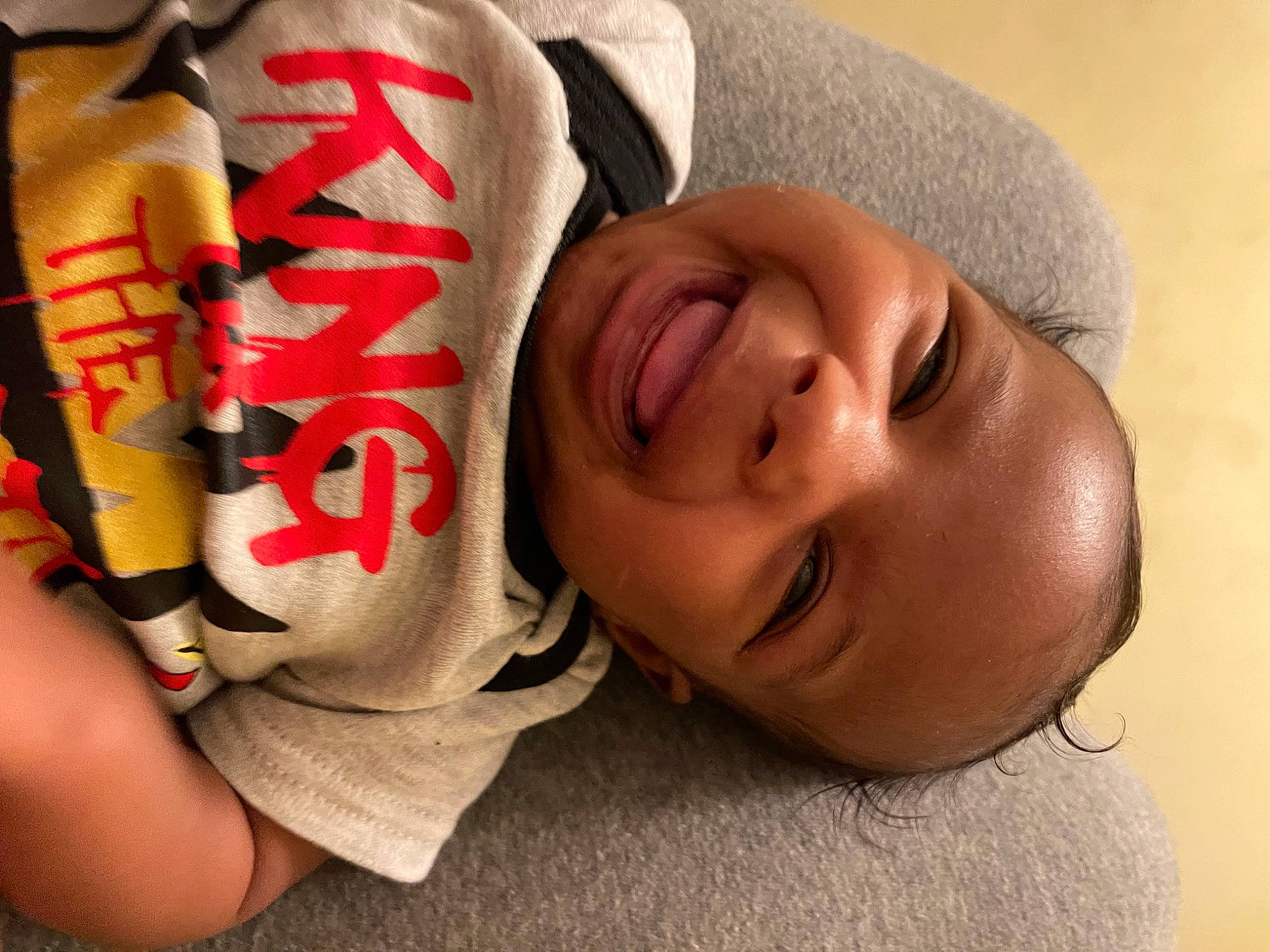 Nehemiah is registered to the contest to win money with this photo: baby, carmine, child, comfort, elbow, eye, eyelash, face, finger, flesh, food, glasses, happy, mouth, nail, nose, person, sleeve, smile, toddler