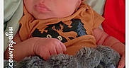 Orrian joined the competition — help win amazing prizes! baby, beanie, bed, bedding, blanket, child, cozy, eyes_open, face, friday, gray_plush, indoors, infant, lying_down, mustard_clothing, newborn, onesie, plush_toy, portrait, text_overlay
