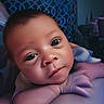 baby, infant, child, portrait, face, wide_eyes, looking_at_camera, lying_down, arms, hands, skin, indoor, bedroom, curtain, patterned_background, soft_lighting, close_up, cozy, photography, cute