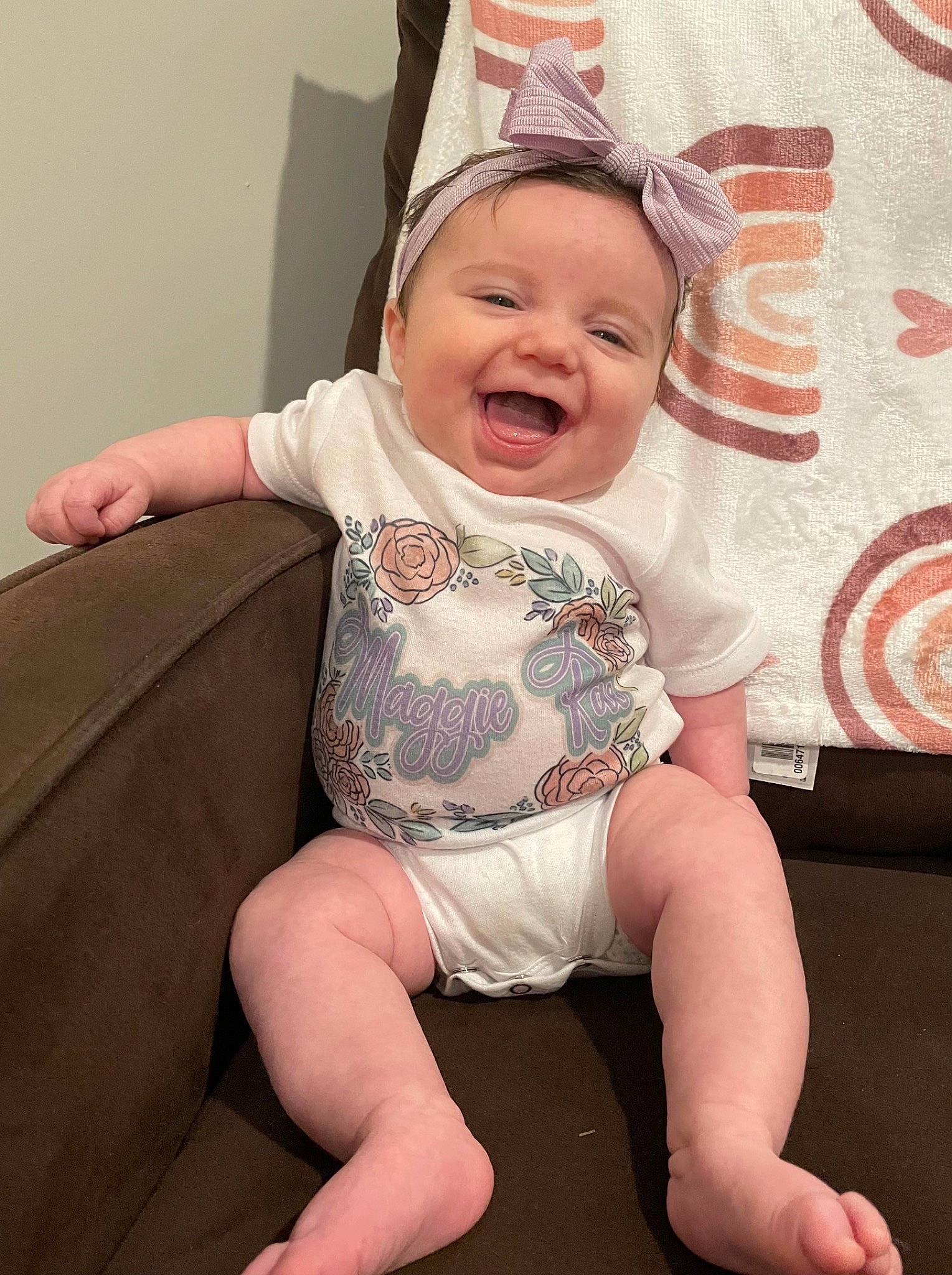 Maggie joined the competition — help win amazing prizes! baby, baby_laughing, baby_toddler_clothing, cheek, child, comfort, eye, finger, gesture, happy, headwear, knee, lap, leg, mouth, person, pink, skin, sleeve, smile