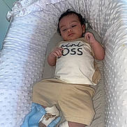 William joined the competition — help win amazing prizes! baby, infant, bassinet, blanket, clothing, socks, footwear, face, person, child, cute, indoors, relaxed, soft, padded, sleeping_area, small_person, portrait, baby_clothes, baby_bed