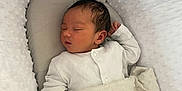 William is registered to the contest to win money with this photo: newborn, baby, sleeping, blanket, bassinet, white_clothing, infant, cozy, soft_texture, peaceful, child, resting, indoors, closeup, head, face, hand, fabric, toddler, comfort