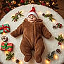 baby, infant, christmas, holiday, festive, onesie, santahat, lights, gifts, pinecones, decorations, cozy, warm, cute, lying_down, fluffy, indoor, floor, celebration, tree