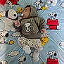 baby, sleeping, pacifier, hoodie, snoopy, woodstock, plush_toys, blanket, cartoon_characters, child, cute, infant, clothing, patterned_pants, soft_toys, indoor, resting, peaceful, nursery, peanuts