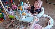 Audrianna joined the competition — help win amazing prizes! baby, baby_walker, blanket, carpet, child, colorful, cute, floor, furniture, happy, indoor, infant, person, plastic_toys, playful, smiling, soft_toys, toys, wooden_toy, young_child