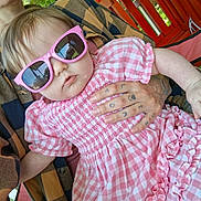 Audrianna is registered to the contest to win money with this photo: accessory, adult, baby, casual, child, closeup, cool, cute, fashion, funny, gingham_dress, greenery, outdoor, person, pink_sunglasses, portrait, red_chair, sitting, summer, tattooed_hand
