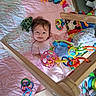 Audrianna joined the competition — help win amazing prizes! baby, blanket, child, colorful, crawling_mat, cute, face, floor, happy, indoors, infant, person, play_gym, playtime, quilt, rings, smile, soft_toys, toy, wooden_frame