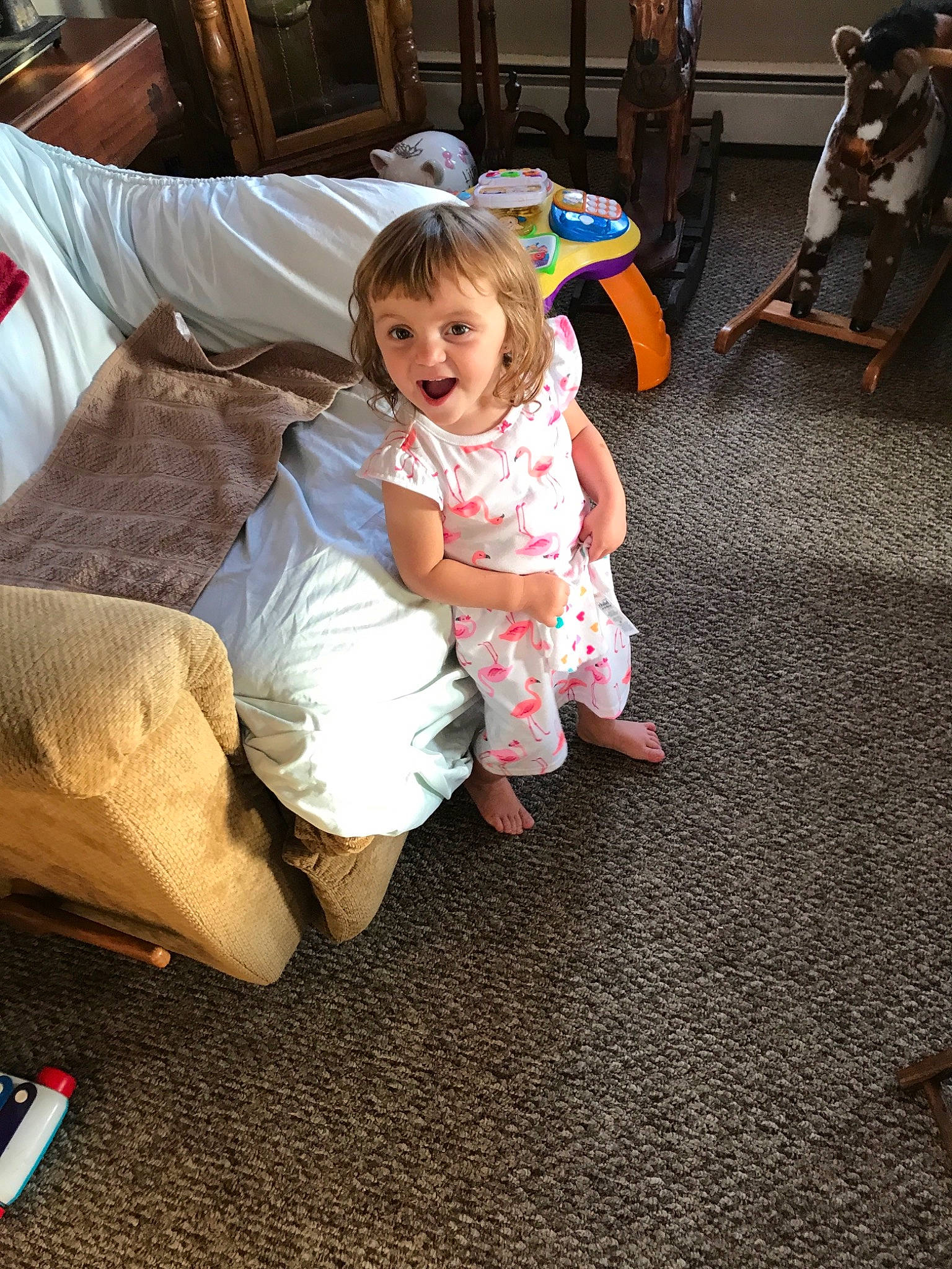 Briana is registered to the contest to win money with this photo: baby, child, family, floor, flooring, fun, lap, leg, person, play, sitting, skin, toddler, vacation, wood