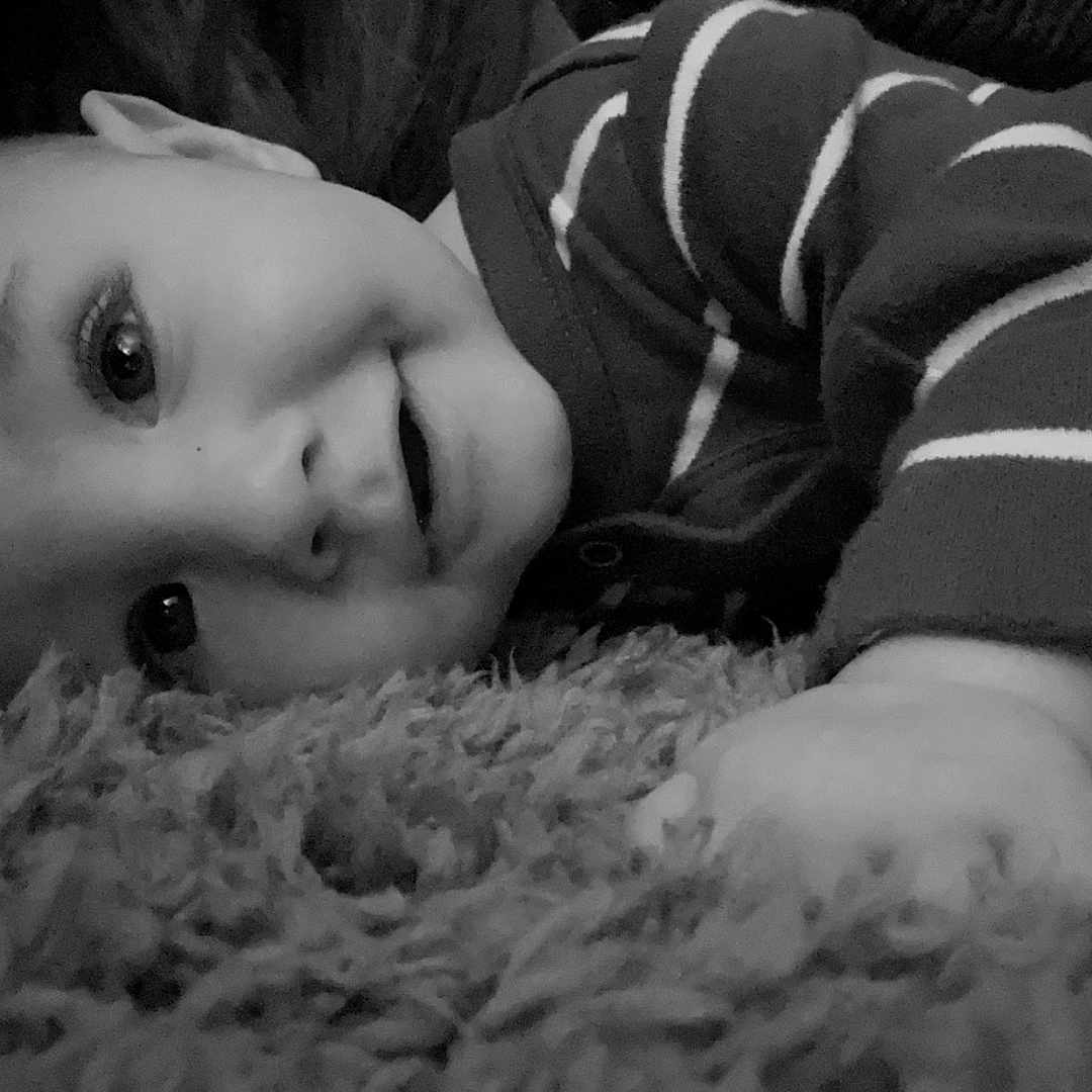 Arlo is registered to the contest to win money with this photo: baby, bodypart, clothing, couch, face, finger, furniture, hand, happy, head, homedecor, indoors, knitwear, mouth, newborn, person, photography, portrait, smile, sweater