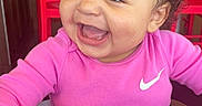 Normani is registered to the contest to win money with this photo: baby, bright_colors, candid, casual, child, curly_hair, cute, happy, high_chair, indoor, joyful, laughter, person, pink_clothing, portrait, red_chair, seatbelt, smiling, toddler, young_child