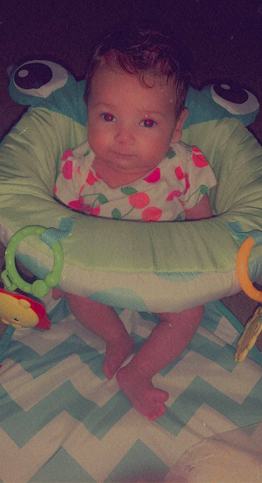 Mckinley is registered to the contest to win money with this photo: arm, baby, baby_products, baby_toddler_clothing, cheek, child, comfort, eye, finger, flooring, fun, head, human_body, mouth, nose, person, pink, skin, sleeve, thumb