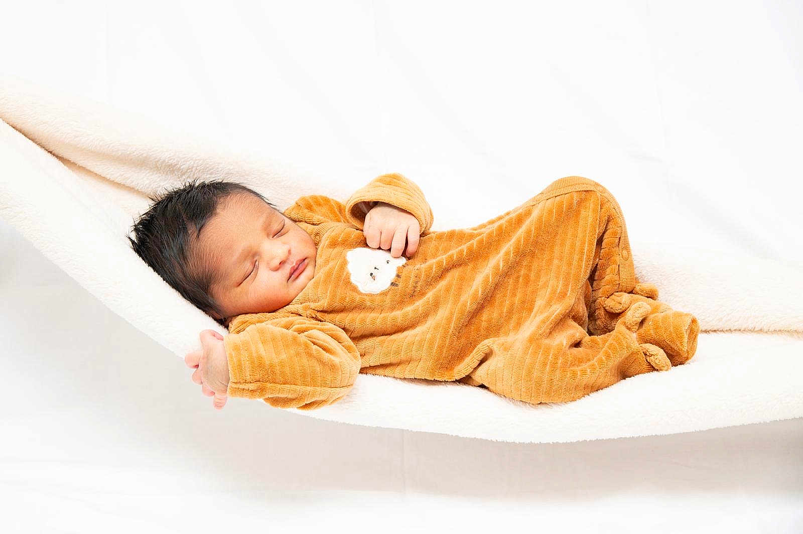 Vihaan participe au concours pour gagner de l'argent avec cette photo : baby, baby_clothes, blanket, child, cozy, cute, face, hammock, indoors, infant, newborn, onesie, orange_clothing, peaceful, portrait, relaxation, resting, sleeping, soft_texture, white_background