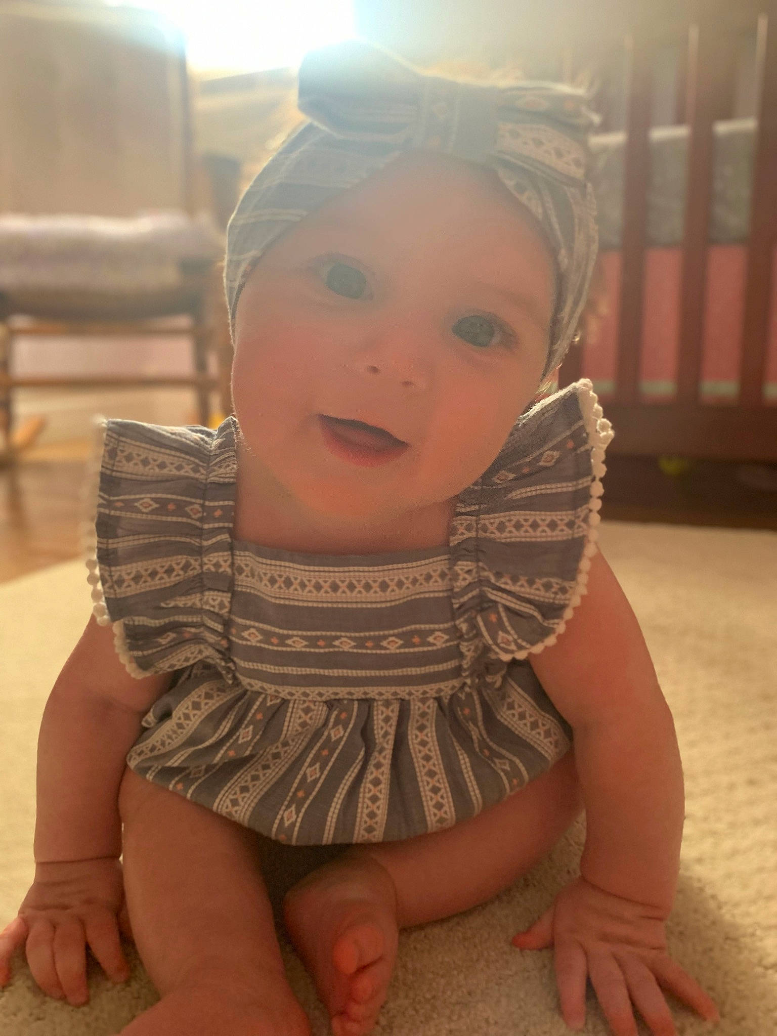 Fiona is registered to the contest to win money with this photo: baby_toddler_clothing, cheek, dress, finger, flooring, fun, gesture, hairstyle, happy, head, headgear, headpiece, headwear, joint, lip, neck, organ, person, shoulder, skin