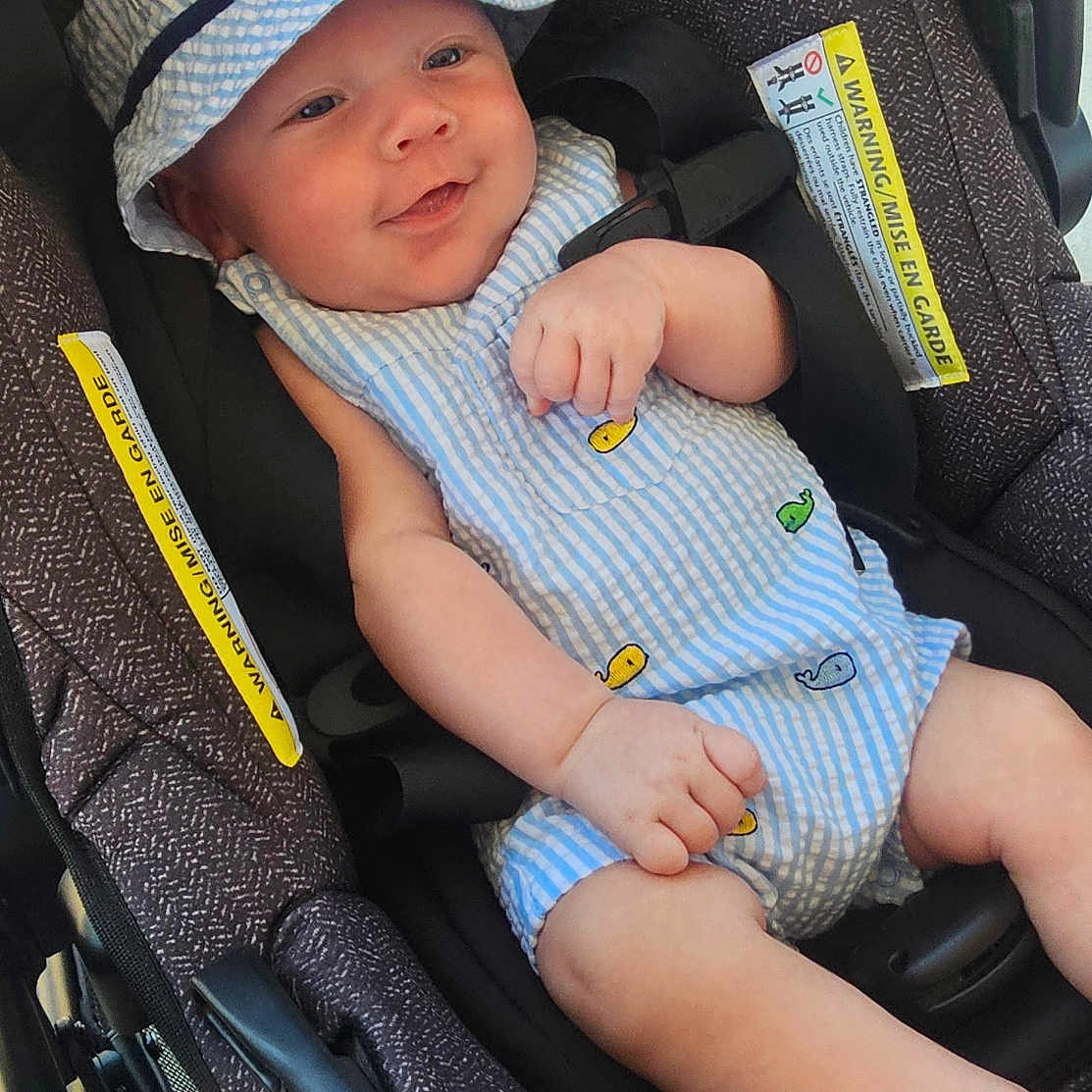 Raiden joined the competition — help win amazing prizes! baby, blue, car_seat, child, comfort, cute, hand, happy, hat, infant, legs, outdoor, pattern, seat_belt, skin, small_person, smile, striped_clothing, summer, white