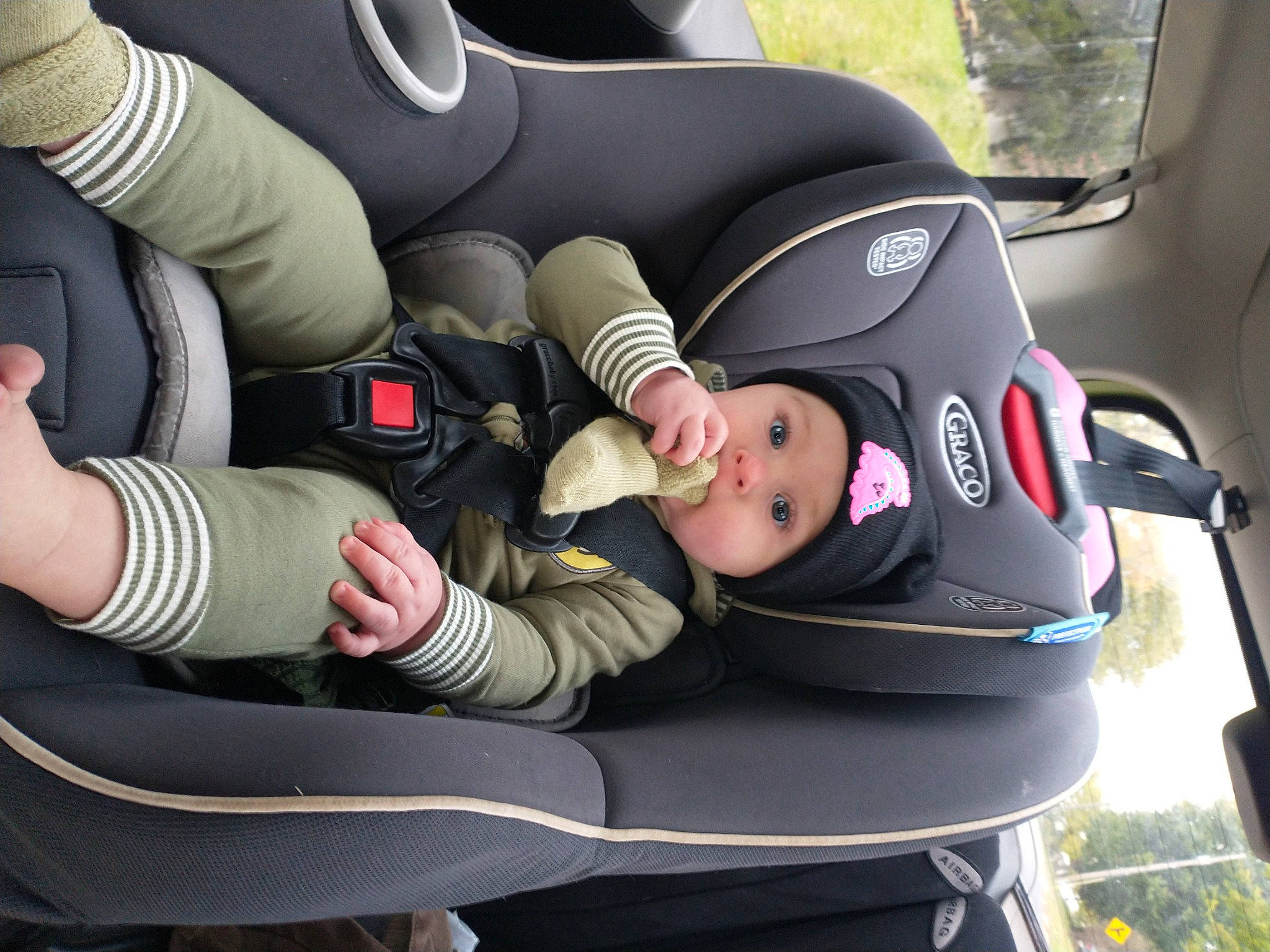 Mary-alice is registered to the contest to win money with this photo: auto_part, automotive_design, baby_carriage, baby_products, car, car_seat, car_seat_cover, child, comfort, family_car, gesture, grass, head_restraint, headwear, motor_vehicle, person, plant, seat_belt, steering_part, toddler