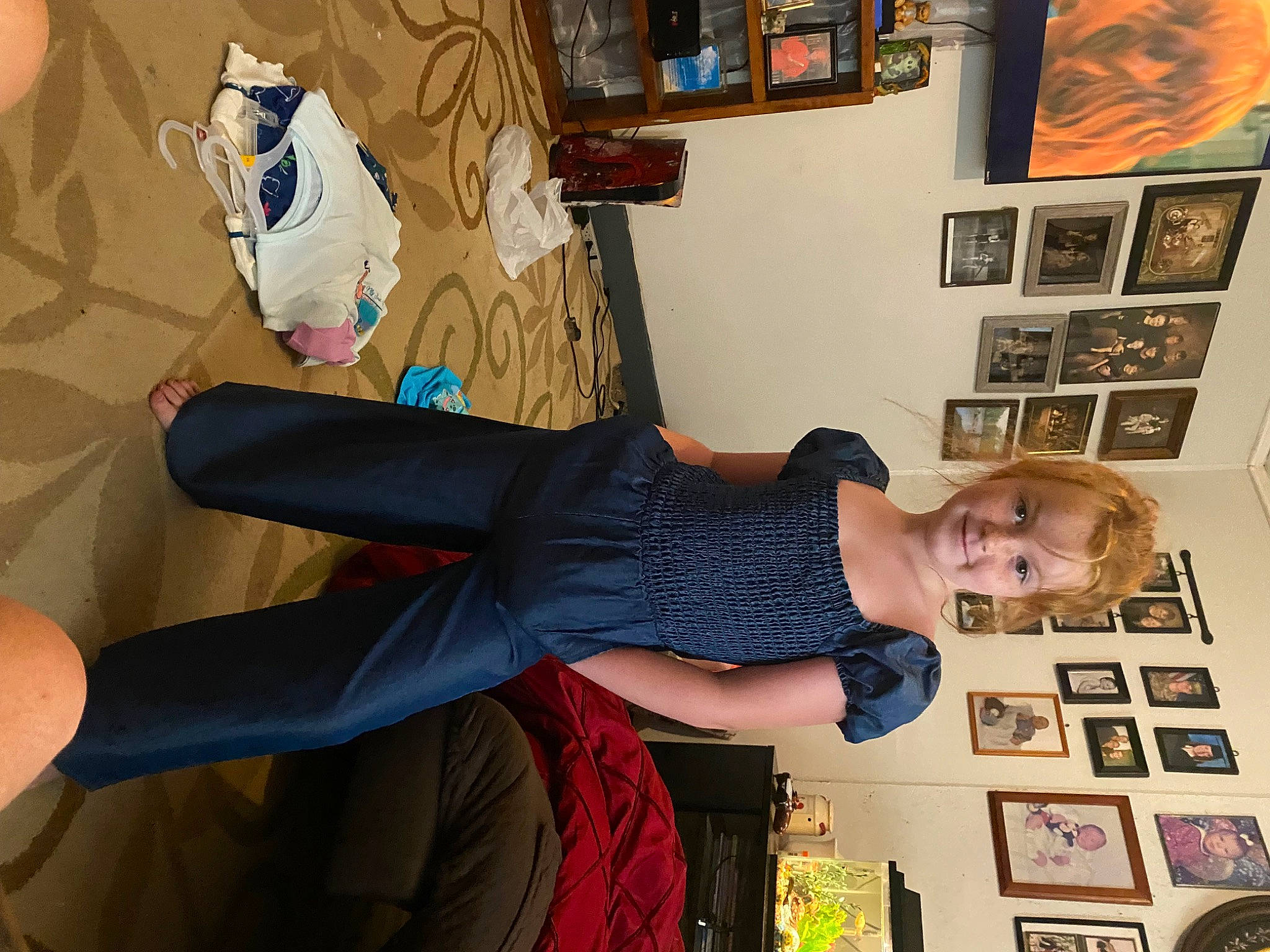 Emma is registered to the contest to win money with this photo: balance, elbow, fashion_design, fun, happy, human_leg, joy, knee, lap, pattern, person, picture_frame, room, sandal, shelf, shelving, sitting, smile, thigh, visual_arts