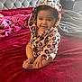 baby, child, smiling, hood, robe, leopard_print, blanket, bed, red, pink, soft, cute, indoors, happy, person, sitting, face, feet, hand, warm