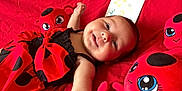 Livine participe au concours pour gagner de l'argent avec cette photo : baby, infant, smile, red, dress, polka_dot, plush_toy, ladybug, blanket, lying_down, cute, child, soft_toy, happy, face, indoors, person, clothing, closeup, portrait