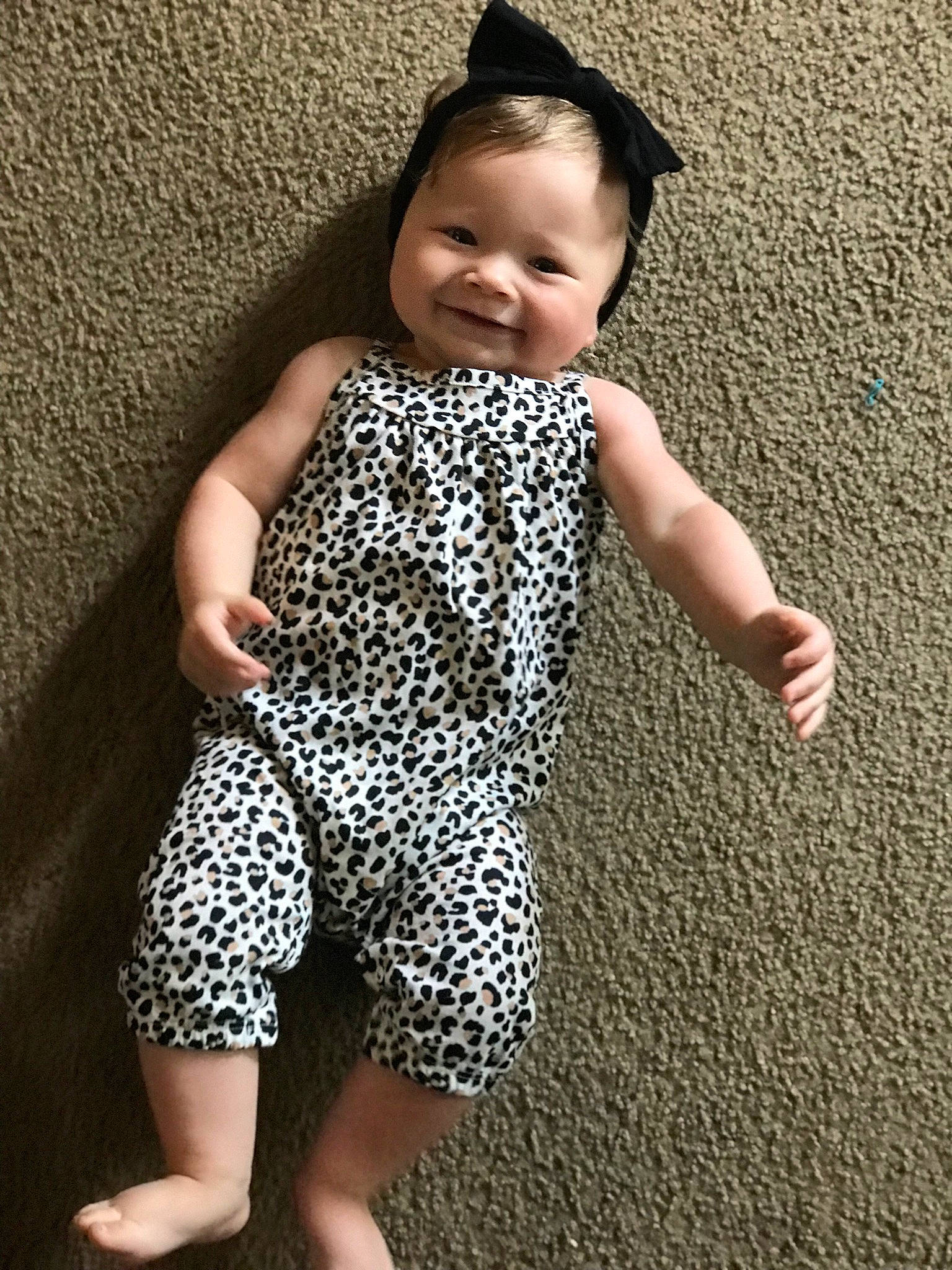 Carlee joined the competition — help win amazing prizes! baby_toddler_clothing, eye, face, finger, floor, flooring, gesture, hand, human_body, joint, joy, leg, one_piece_garment, person, shoulder, skin, sleeve, smile, standing, textile