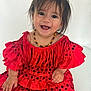 Lucia a rejoint le concours — aidez-le/la à gagner de superbes lots ! toddler, child, smiling, red_dress, polka_dots, fringe, necklace, happy, portrait, indoors, cute, baby, fashion, colorful, sitting, young_child, person, face, hair, joyful