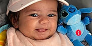 Lucia a rejoint le concours — aidez-le/la à gagner de superbes lots ! baby, child, pink_cap, bib, plush_toy, stitch, blue_toy, smiling, tongue_out, baby_seat, clothing, cute, infant, face, closeup, indoor, soft_toy, happy, person, adorable