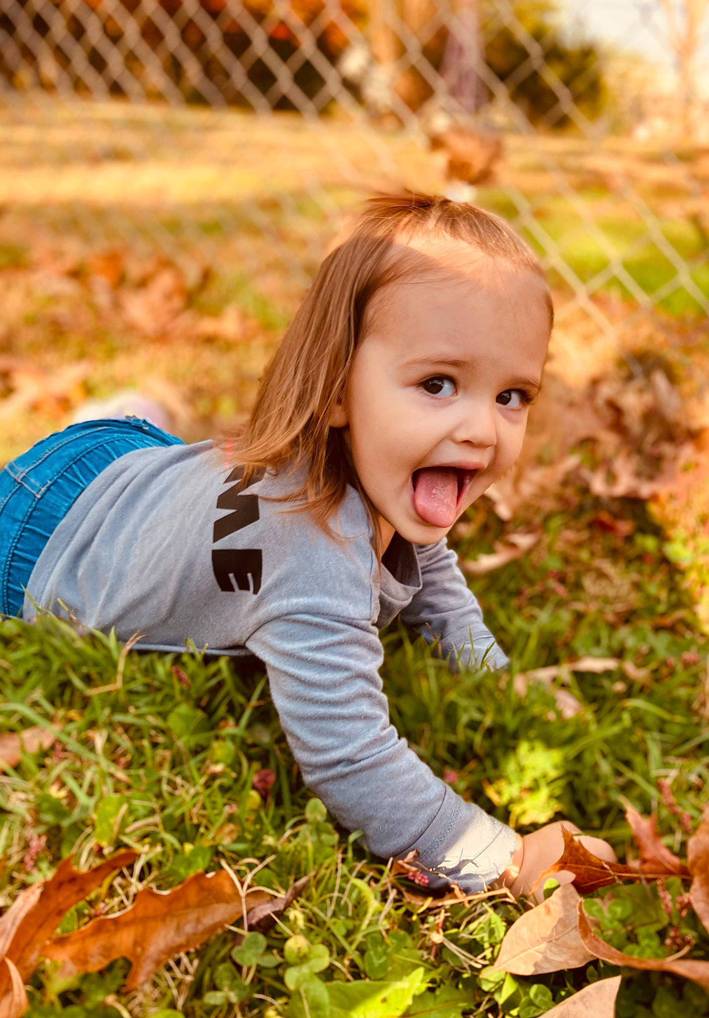 Madelynn joined the competition — help win amazing prizes! blond, child, face, fence, flash_photography, fun, grass, grass_family, grassland, happy, leaf, meadow, people_in_nature, person, plant, prairie, smile, sunlight, surprise, t_shirt