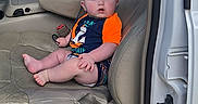 Dayton joined the competition — help win amazing prizes! baby, blue_clothing, car, casual, child, curious, door_frame, house, infant, interior, leather_seat, open_door, orange_clothing, person, seatbelt, sidewalk, sitting, suburban, vehicle, window