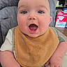 baby, child, high_chair, bib, face, mouth_open, expression, surprised, infant, clothing, skin, hand, indoor, furniture, home, person, seat, feeding, cute, young