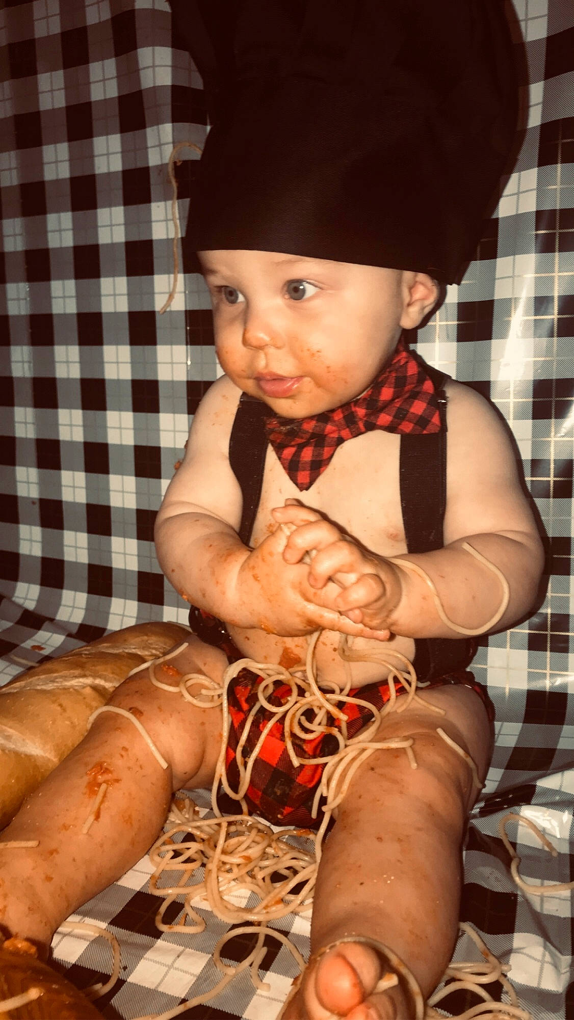 Sasha is registered to the contest to win money with this photo: arm, baby, baby_toddler_clothing, comfort, costume_hat, eye, finger, hand, happy, hat, headwear, orange, pattern, person, plaid, sitting, sun_hat, tartan, thigh, toddler